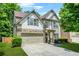 Beautiful two-story home featuring a stone facade, two-car garage, and well-maintained landscaping at 1326 Castleberry Dr, Buford, GA 30518