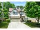 Attractive two-story home with a well-manicured lawn, stone accents, and an attached two-car garage at 1326 Castleberry Dr, Buford, GA 30518