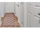 Hallway with wood floors, white doors, and a patterned rug running along the floor at 1326 Castleberry Dr, Buford, GA 30518