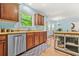 Bright kitchen showcasing wood cabinets and a stainless steel dishwasher next to the breakfast nook at 1326 Castleberry Dr, Buford, GA 30518