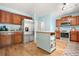Kitchen area with stainless steel appliances, island, wood cabinets and hardwood floors at 1326 Castleberry Dr, Buford, GA 30518