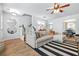 Bright living room with modern decor, stylish mirrors, and a cozy seating area near the dining space at 1326 Castleberry Dr, Buford, GA 30518