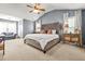 Spacious main bedroom with vaulted ceilings, a large bed, and neutral tones at 1326 Castleberry Dr, Buford, GA 30518