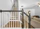 Staircase with wood steps and white and black banister leading to the second floor at 1326 Castleberry Dr, Buford, GA 30518