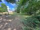 Large backyard with a combination of green lawn and natural wooded areas, providing privacy and space at 4305 Evans Farms Dr, Cumming, GA 30040