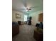 Cozy bedroom with a ceiling fan, window, and a black shelf with decorative items at 4305 Evans Farms Dr, Cumming, GA 30040