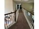 Upstairs hallway with carpet, wood and white banister, and view of the living room at 4305 Evans Farms Dr, Cumming, GA 30040