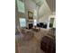 Spacious living room with fireplace, ceiling fan, lots of windows, and comfortable seating at 4305 Evans Farms Dr, Cumming, GA 30040