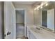 A bright bathroom features a single sink vanity and views to an adjacent bedroom at 5052 Hickory Cir, Ellenwood, GA 30294