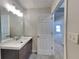 Bathroom boasts a vanity with modern fixtures and a door leading to another room at 5052 Hickory Cir, Ellenwood, GA 30294