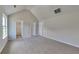A spacious bedroom features vaulted ceilings, neutral paint, and carpet flooring at 5052 Hickory Cir, Ellenwood, GA 30294