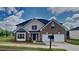 Charming two-story brick home with a well-manicured lawn, two-car garage, and attractive landscaping at 5052 Hickory Cir, Ellenwood, GA 30294