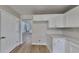 Bright kitchen featuring modern white cabinets, ample countertop space, and wood flooring throughout at 5052 Hickory Cir, Ellenwood, GA 30294