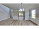 Bright living room with wood flooring, decorative trim, and large windows offering plenty of natural light at 5052 Hickory Cir, Ellenwood, GA 30294