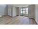 Inviting living room featuring wood flooring, a large window, and neutral paint, creating a cozy atmosphere at 5052 Hickory Cir, Ellenwood, GA 30294