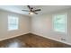 Bedroom with ceiling fan, hardwood floors, and two large windows at 5312 Brittany Trl, Atlanta, GA 30349