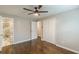 Bedroom showcasing a ceiling fan, hardwood floors, closet, and bathroom at 5312 Brittany Trl, Atlanta, GA 30349