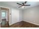Bedroom featuring a ceiling fan, closet, and hardwood flooring at 5312 Brittany Trl, Atlanta, GA 30349
