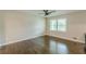 Bedroom featuring hardwood floors, large windows, ceiling fan, and neutral paint at 5312 Brittany Trl, Atlanta, GA 30349