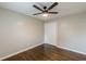 A spacious bedroom featuring a ceiling fan, hardwood flooring, and double closets at 5312 Brittany Trl, Atlanta, GA 30349