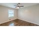 A bright bedroom with a ceiling fan and hardwood floors is illuminated by a window at 5312 Brittany Trl, Atlanta, GA 30349