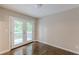 Cozy bedroom with hardwood floors and a private balcony overlooking the backyard at 5312 Brittany Trl, Atlanta, GA 30349