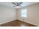 Cozy bedroom with a ceiling fan, hardwood floors, and a bright window at 5312 Brittany Trl, Atlanta, GA 30349