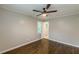 Bedroom showcasing a ceiling fan, hardwood floors, and a doorway to another room at 5312 Brittany Trl, Atlanta, GA 30349
