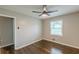 A comfortable bedroom with natural light, ceiling fan, and sleek hardwood flooring at 5312 Brittany Trl, Atlanta, GA 30349