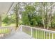 The deck railing faces out to a tranquil backyard setting with mature trees at 5312 Brittany Trl, Atlanta, GA 30349