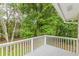 A gray painted deck overlooks a private yard filled with mature trees at 5312 Brittany Trl, Atlanta, GA 30349