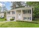 Well-maintained two-story home with brick facade, covered porch, and mature landscaping at 5312 Brittany Trl, Atlanta, GA 30349