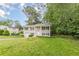 Charming two-story home with a lush lawn, attached garage and welcoming front porch with green bushes at 5312 Brittany Trl, Atlanta, GA 30349