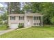 Charming two-story home featuring a well-maintained lawn and a classic brick facade with black shutters at 5312 Brittany Trl, Atlanta, GA 30349