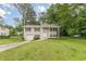 Attractive two-story home with attached garage, front lawn, and mature shade trees at 5312 Brittany Trl, Atlanta, GA 30349
