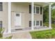 Inviting front porch with white columns, brick facade, and a bright white front door at 5312 Brittany Trl, Atlanta, GA 30349