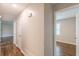 Bright hallway with hardwood floors and neutral paint leads to bedrooms at 5312 Brittany Trl, Atlanta, GA 30349