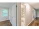 A bright hallway leading to a bedroom with hardwood flooring and natural light at 5312 Brittany Trl, Atlanta, GA 30349
