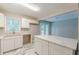 Bright kitchen features island seating, white cabinets, and a view of the private balcony at 5312 Brittany Trl, Atlanta, GA 30349