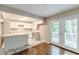 Bright kitchen with white cabinets, marble countertops, stainless steel appliances, and deck access at 5312 Brittany Trl, Atlanta, GA 30349