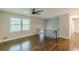 Spacious open-concept living room with hardwood floors, ceiling fan, and lots of natural light at 5312 Brittany Trl, Atlanta, GA 30349