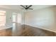 Hardwood floors and view of the kitchen and back deck through the French doors in the open-concept living space at 5312 Brittany Trl, Atlanta, GA 30349