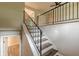 Modern staircase with dark wood treads and black metal railing, leading to an open upper level at 5312 Brittany Trl, Atlanta, GA 30349