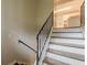 Classic staircase featuring wood and white steps with iron railing, leading up to the second floor at 5312 Brittany Trl, Atlanta, GA 30349