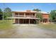 Two story home with a metal roof and gravel driveway at 999 Wiley Bridge Rd, Woodstock, GA 30188