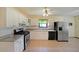 Well-lit kitchen with white cabinetry, modern appliances, and tile flooring at 999 Wiley Bridge Rd, Woodstock, GA 30188