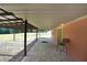 Covered outdoor patio with pavers, chair, and view of the yard at 999 Wiley Bridge Rd, Woodstock, GA 30188