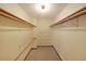 Functional walk-in closet featuring shelving, rods, and carpet at 999 Wiley Bridge Rd, Woodstock, GA 30188