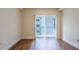 Cozy bedroom featuring wood flooring, a large window, and neutral wall color at 1074 Peachtree Ne Walk # B404, Atlanta, GA 30309