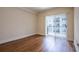 Bedroom with laminate wood flooring and sliding glass doors at 1074 Peachtree Ne Walk # B404, Atlanta, GA 30309
